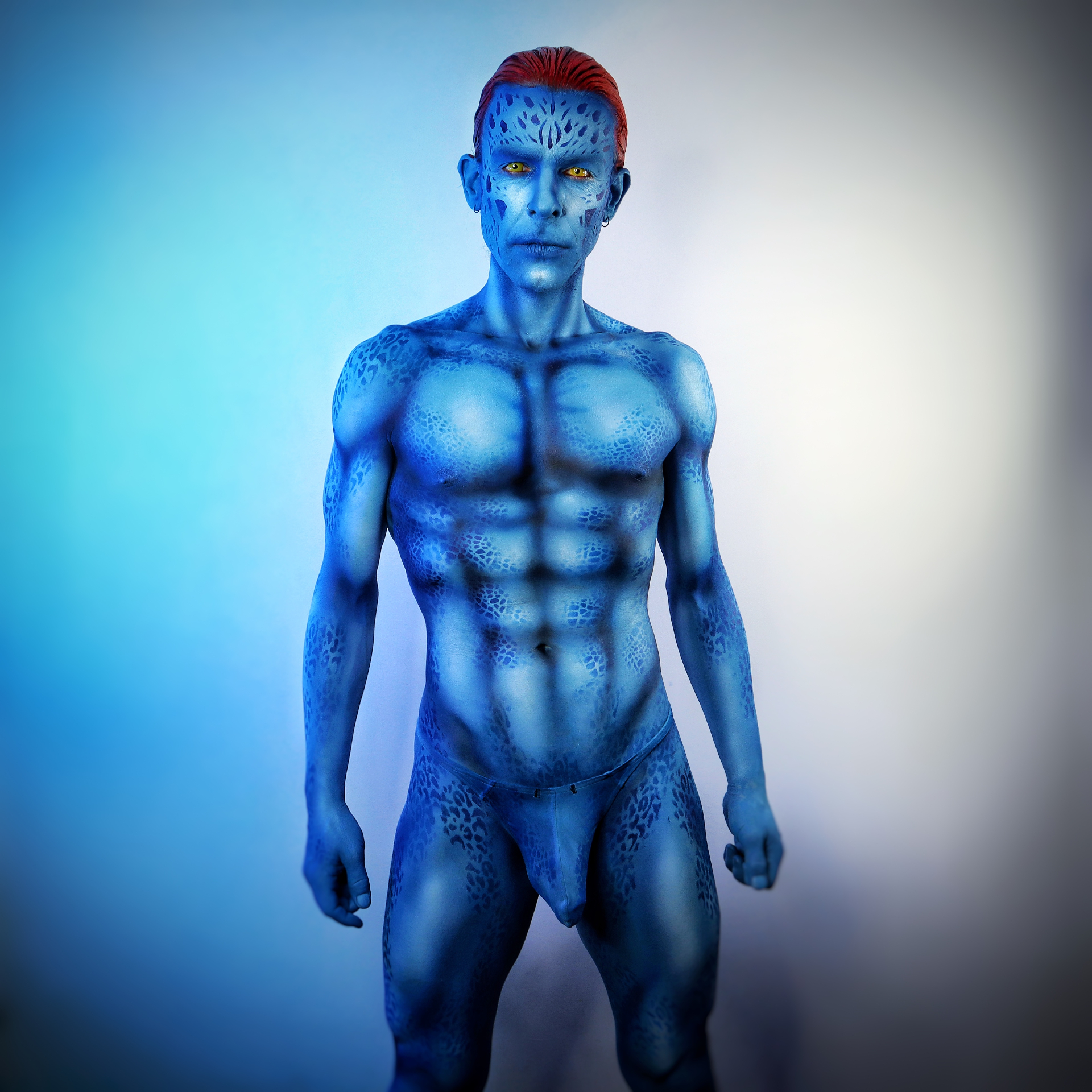 Full body paint of MYSTIQUE — Blue scaled body paint with signature red hair — X-Men inspired.