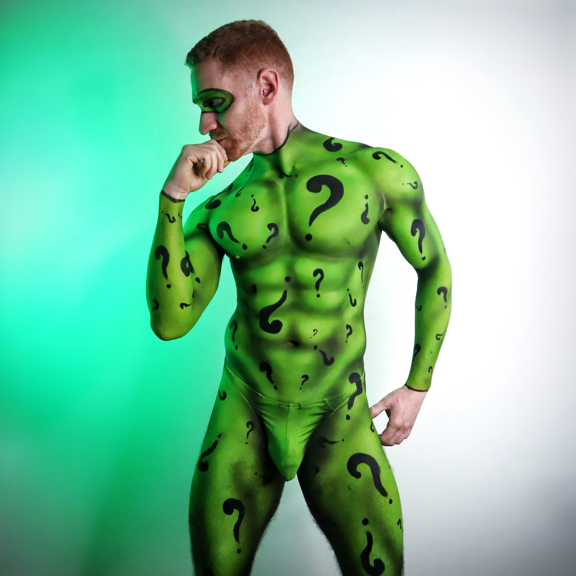Full body paint of RIDDLER — Hand-painted question mark suit on bare skin.